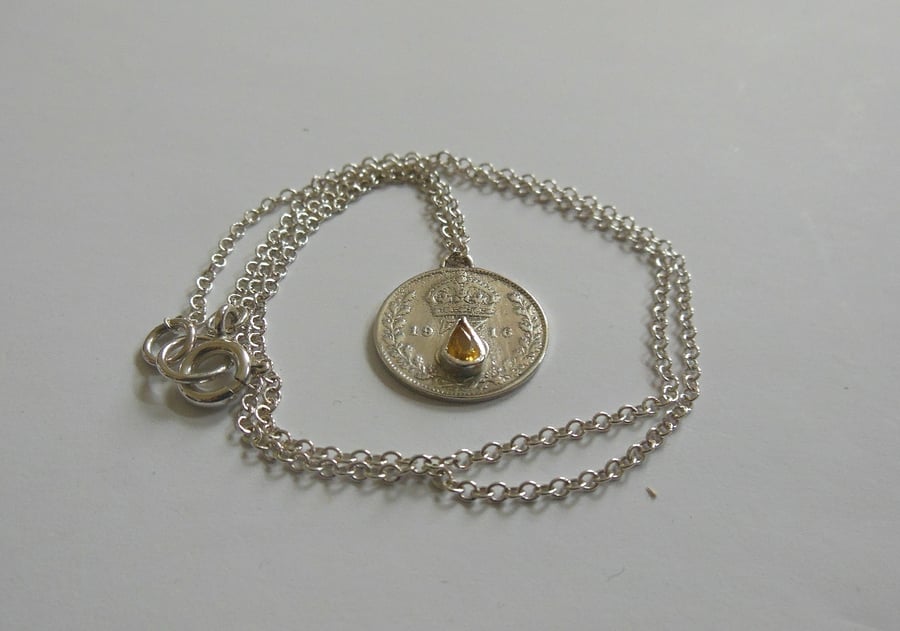 1916 threepence set with golden yellow sapphire