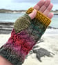 Hand knitted fingerless gloves in cable stitch pattern 