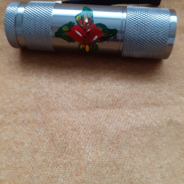 Silver mini LED torch with red canal art style rose