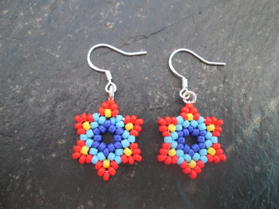 Red, blue and yellow Huichol inspired star flower beaded dangle earrings