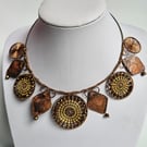 Necklace featuring Dorset Buttons with copper pendants and beads