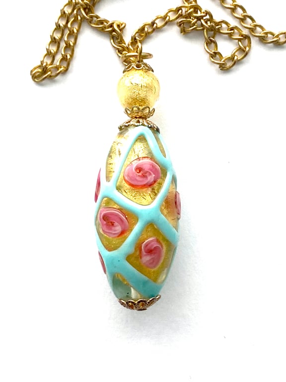  Murano glass pendant with gold and pink rose decorated bead and gold chain.