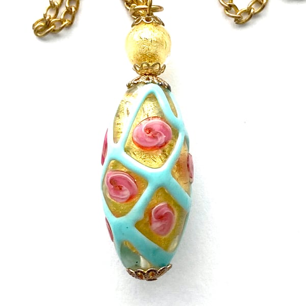  Murano glass pendant with gold and pink rose decorated bead and gold chain.