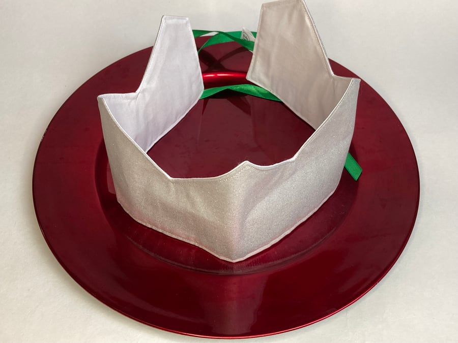 Christmas Crowns. Set of four silver crowns with different coloured ribbons.