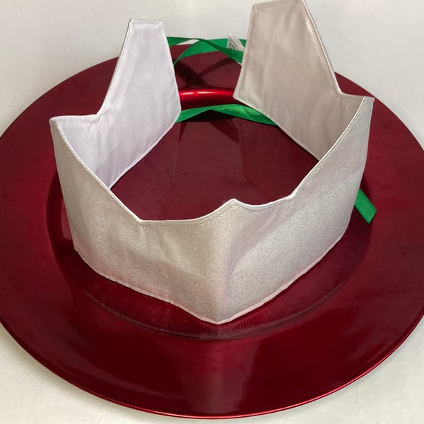 Christmas Crowns. Set of four silver crowns with different coloured ribbons.