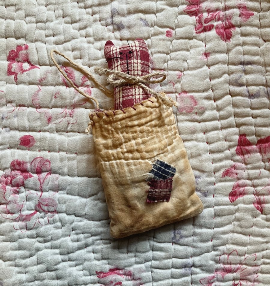 Kitten in vintage quilt pocket