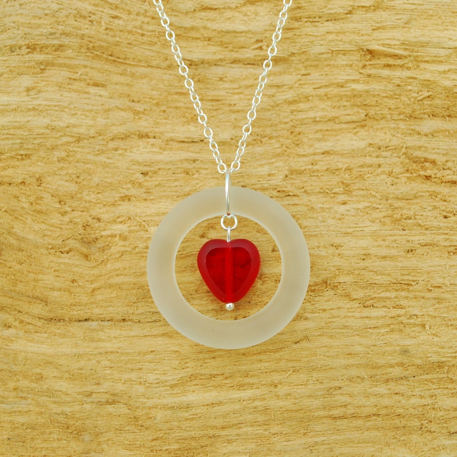 Glass ring pendant with red heart