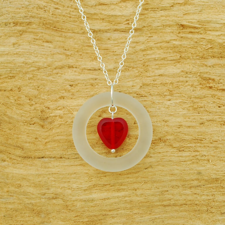 Glass ring pendant with red heart