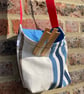 Peg bag with red shoulder strap. Stripes in blue and cream