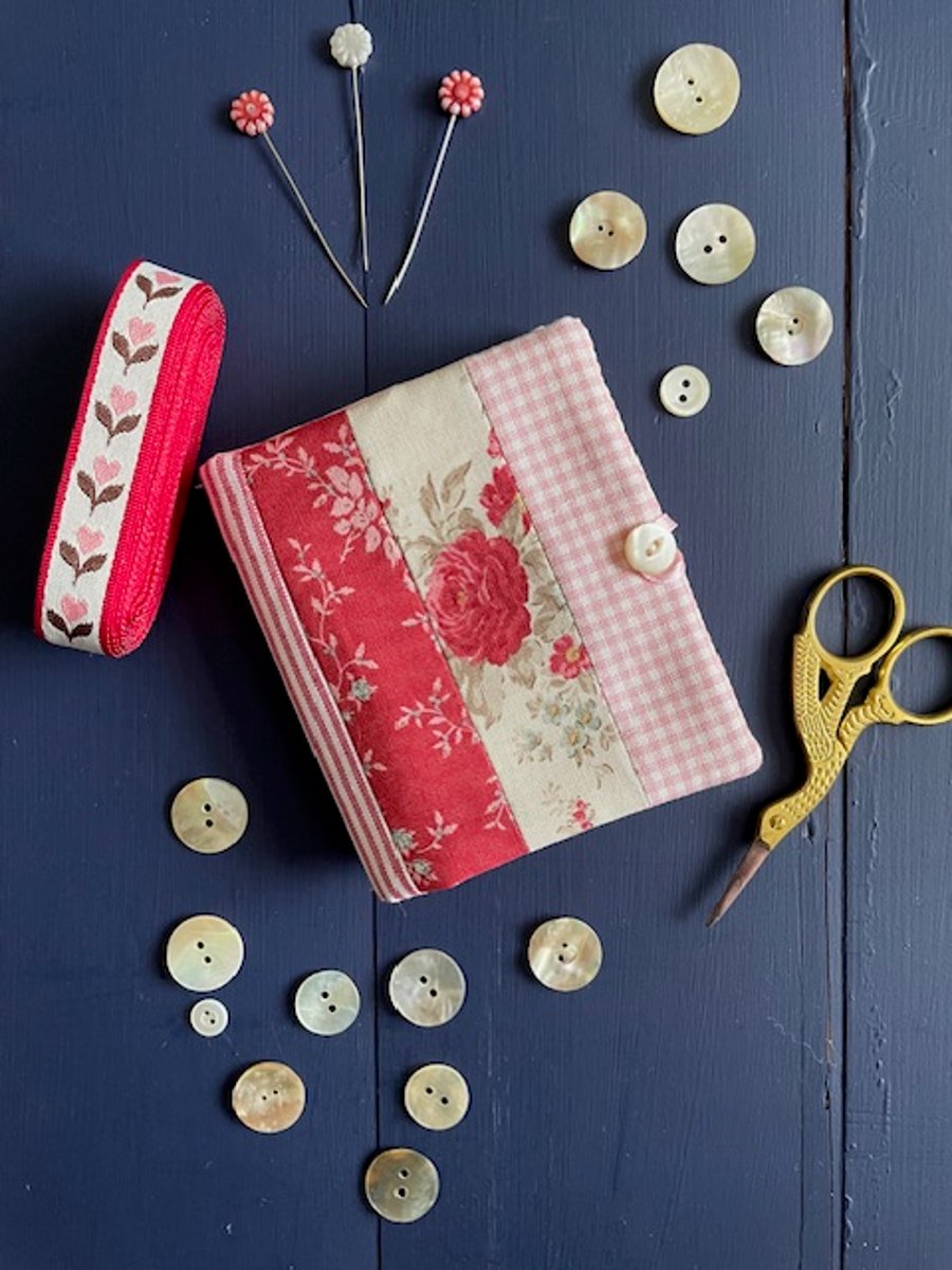 Patchwork stripe needle case made from Tilda fabric in shades of red and pink