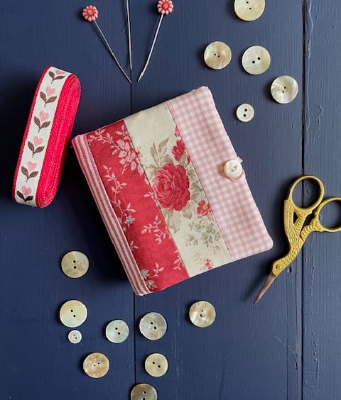 Patchwork stripe needle case made from Tilda fabric in shades of red and pink