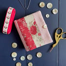Patchwork stripe needle case made from Tilda fabric in shades of red and pink
