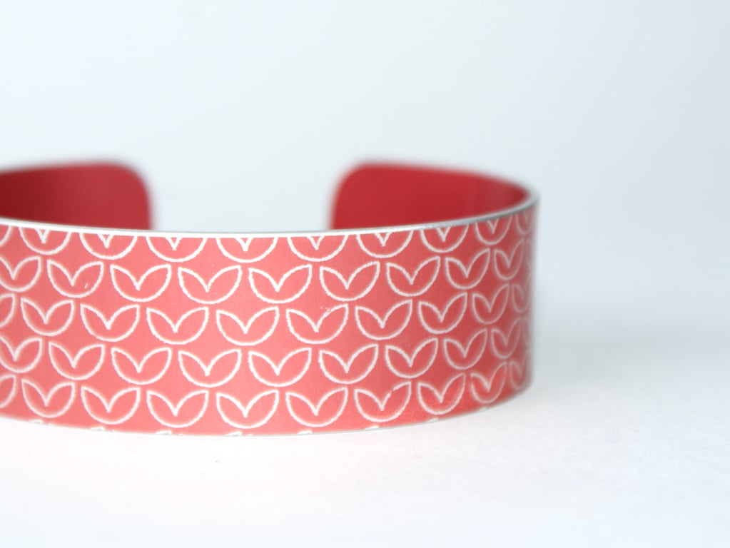 Leaf pattern aluminium cuff light orangey red