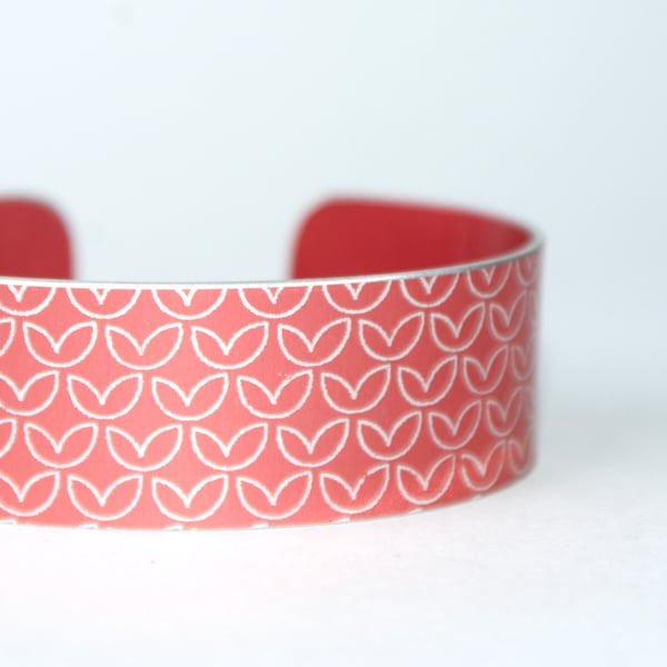 Leaf pattern aluminium cuff orangey red