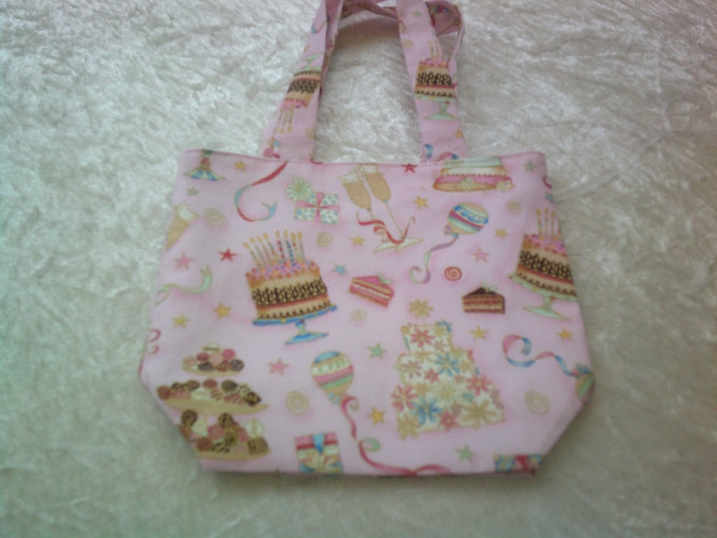 Fabric bag with Cakes and Streamers on a Pale Pink Background