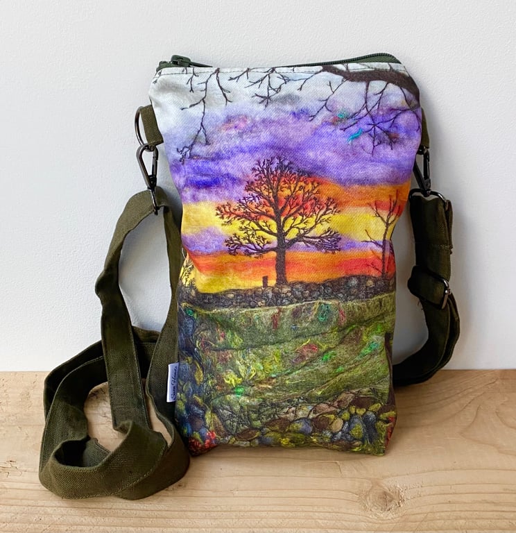 Sunrise tree and landscape cross body mobile phone bag with shoulder strap.