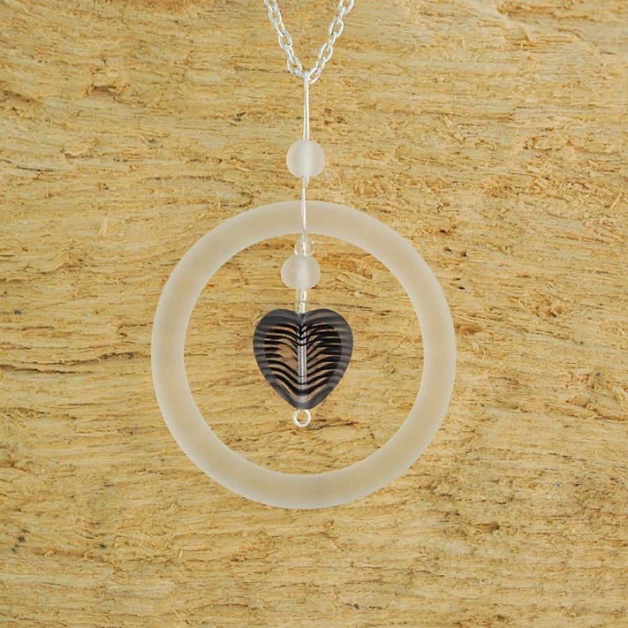 Glass ring pendant with black patterned heart