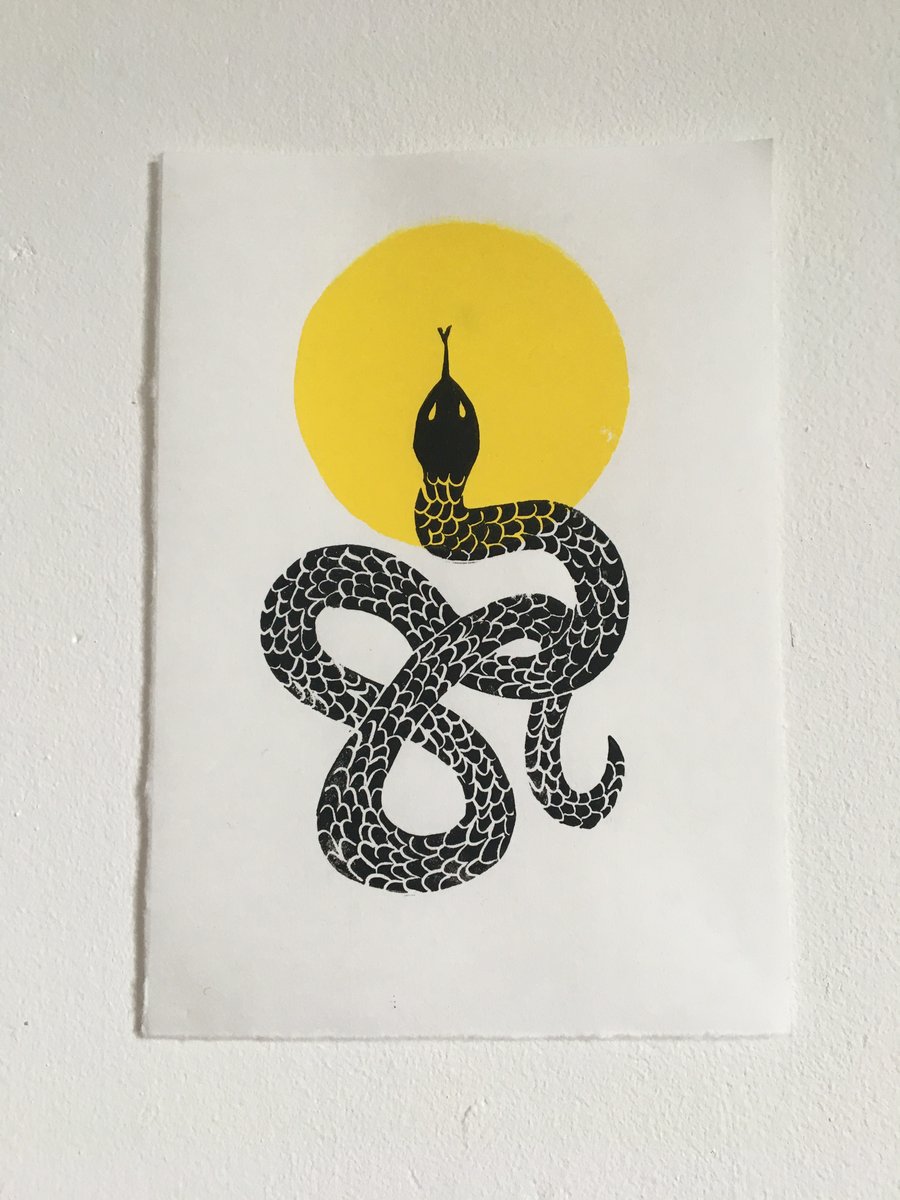 Solar, linocut snake and sun on handmade paper.
