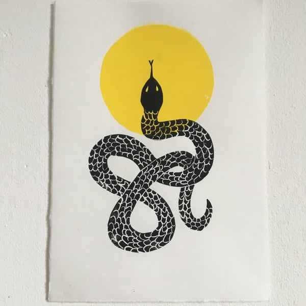 Solar, linocut snake and sun on handmade paper.