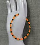 UV Reactive Orange Glass Bead and Black Glass Bicone Elastic Bracelet - Image 5