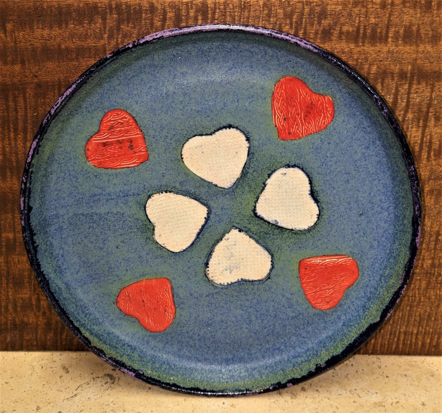 Gorgeous stoneware presentation dishes, deep turquoise with decorations.