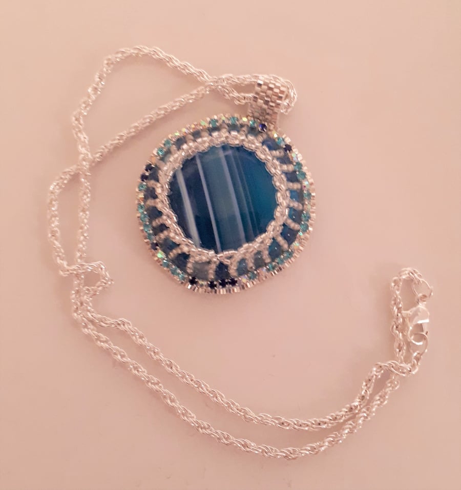 Bead embroidered Blue Banded Agate pendant on a silver tone chain