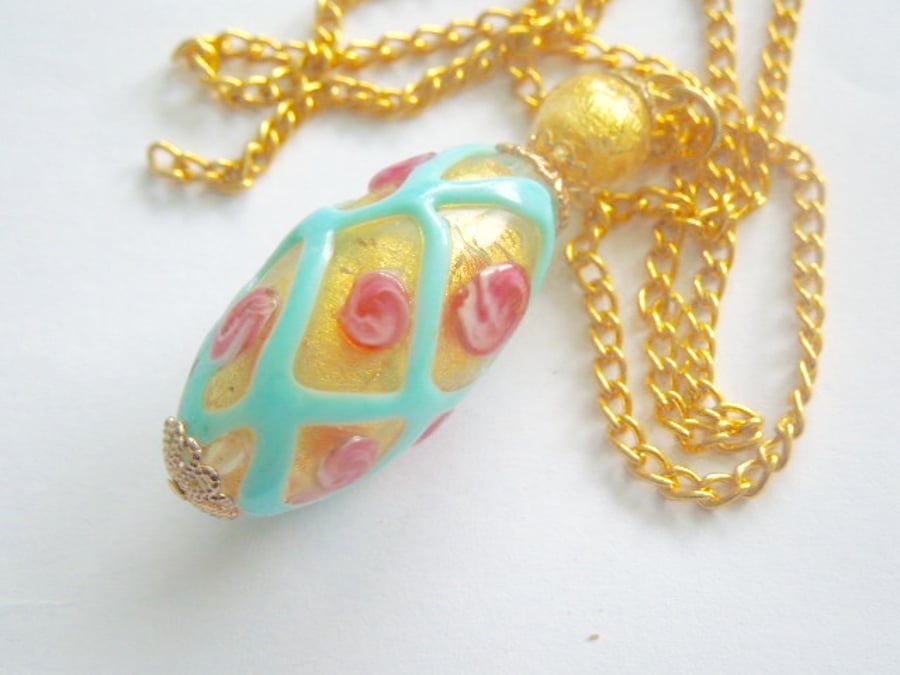  Murano glass pendant with gold and pink rose decorated bead and gold chain.