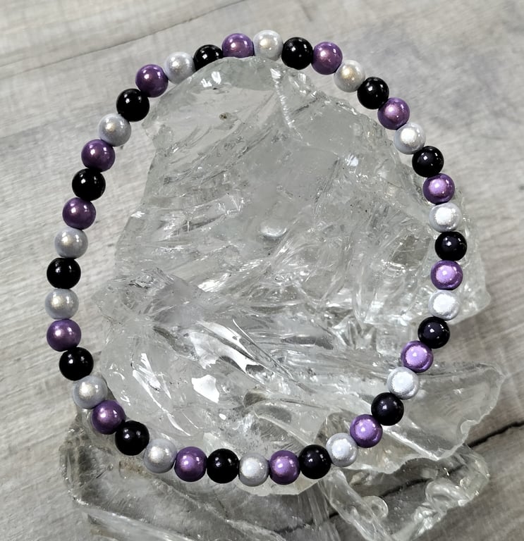 AL146A  Purple, black and silver miracle bead elasticated anklet 