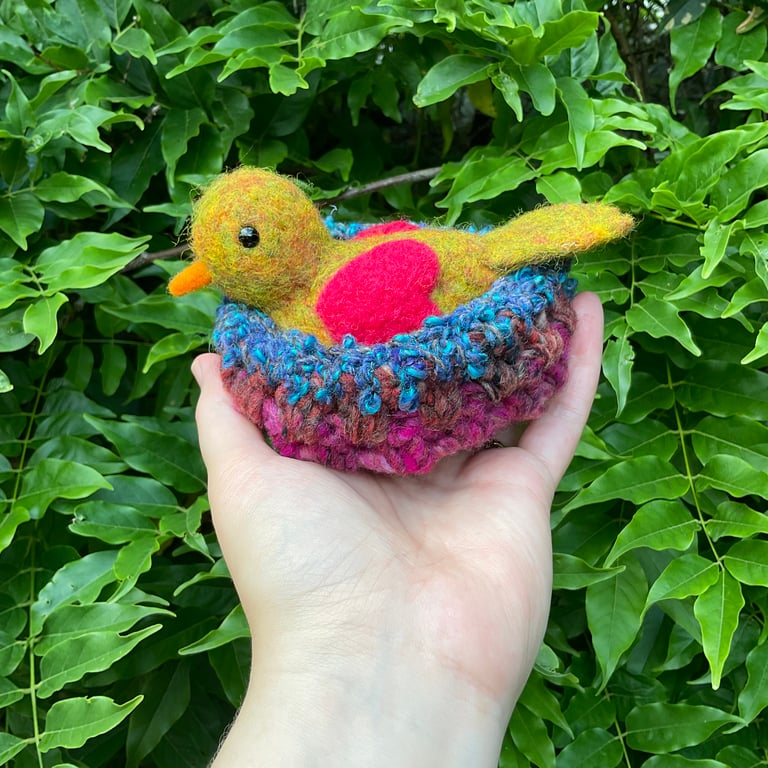 Sweet bird in a beautiful nest with pink heart wings