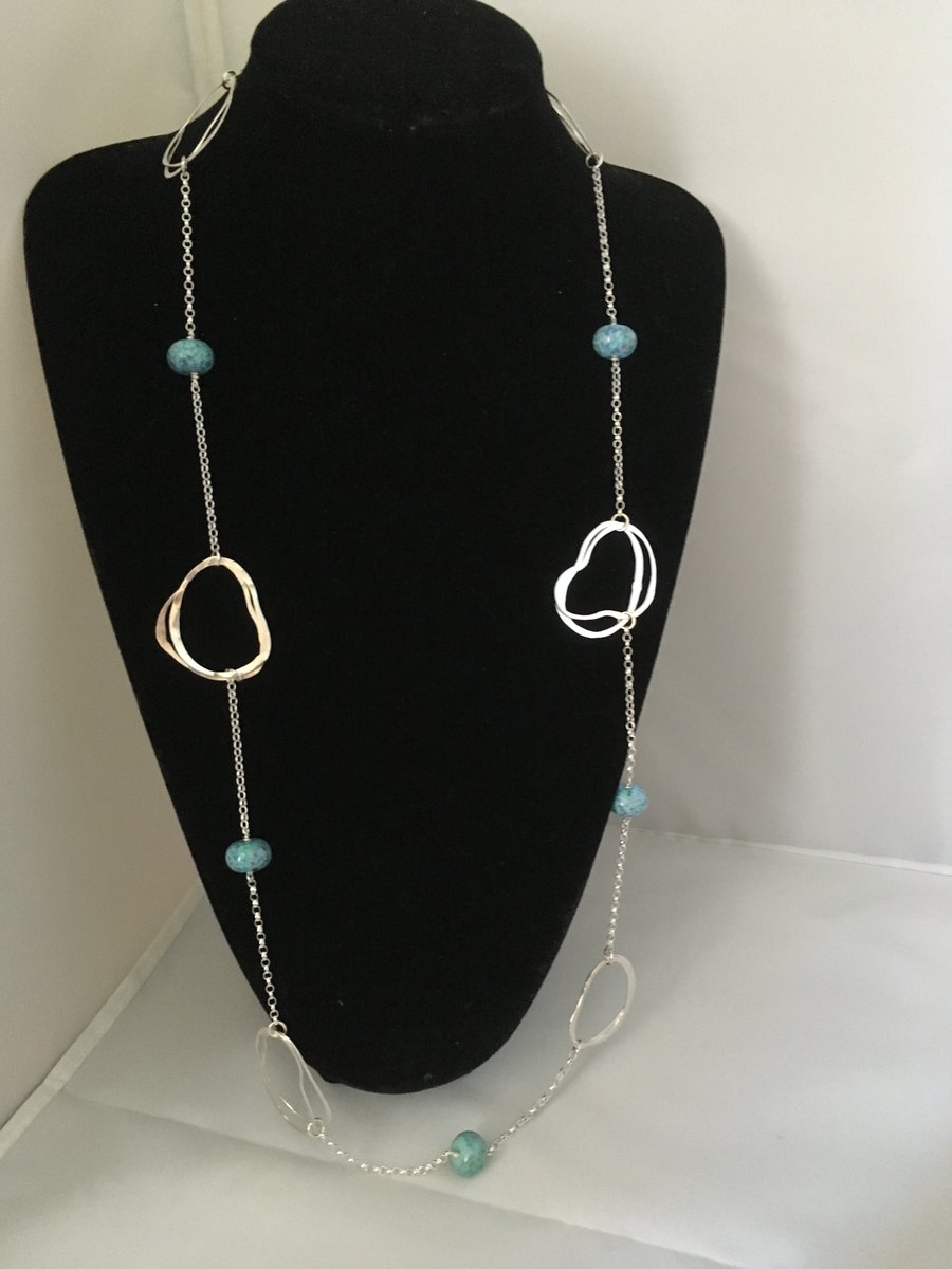 Contemporary long silver and glass loop necklace