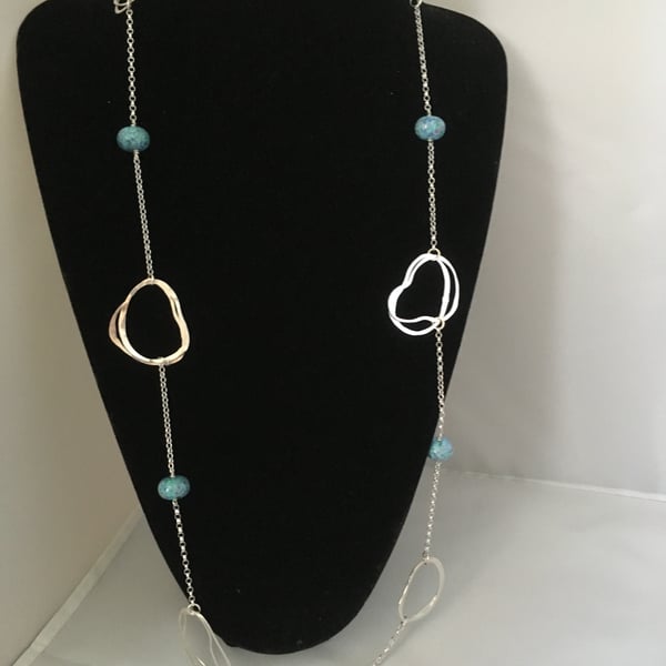 Contemporary long silver and glass loop necklace