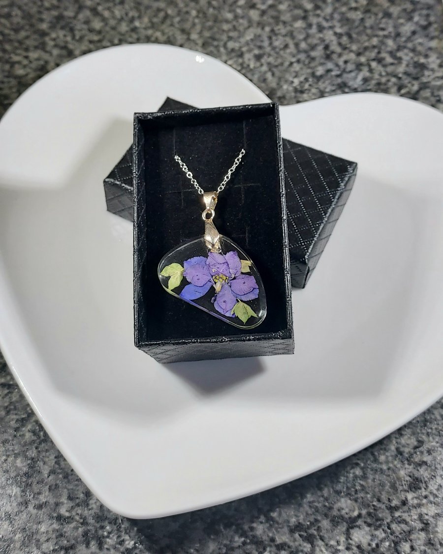 Pressed violet pendant necklace on a  silver plated chain. 