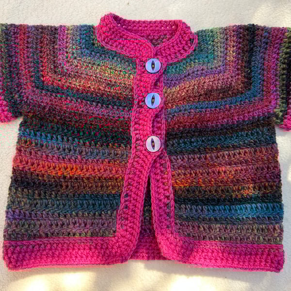 Short sleeved baby cardigan.