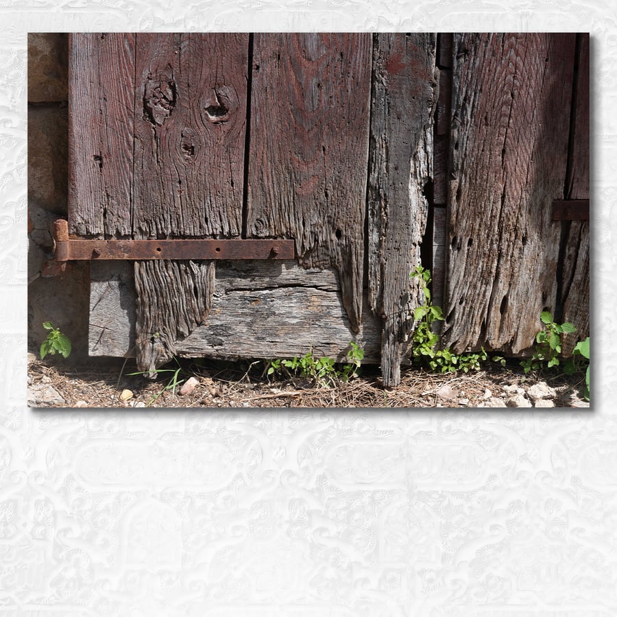 Old weathered door with character in Monticchiello, Tuscany, Italy
