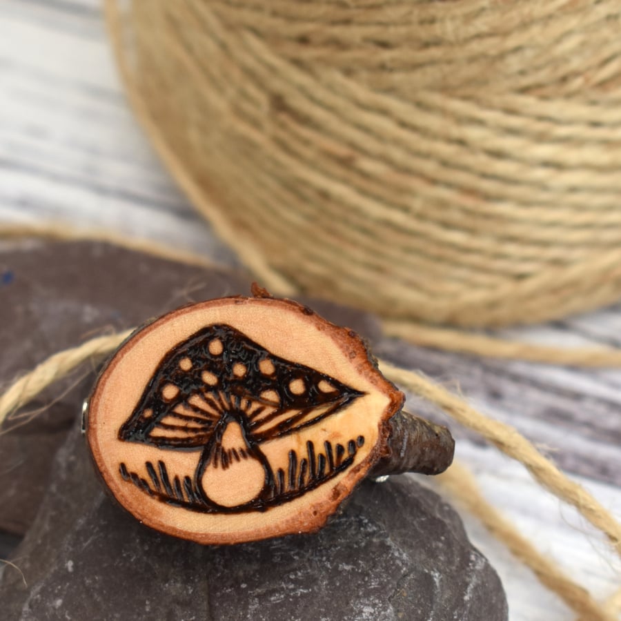 Teeny fungi brooch hand burned using pyrography.