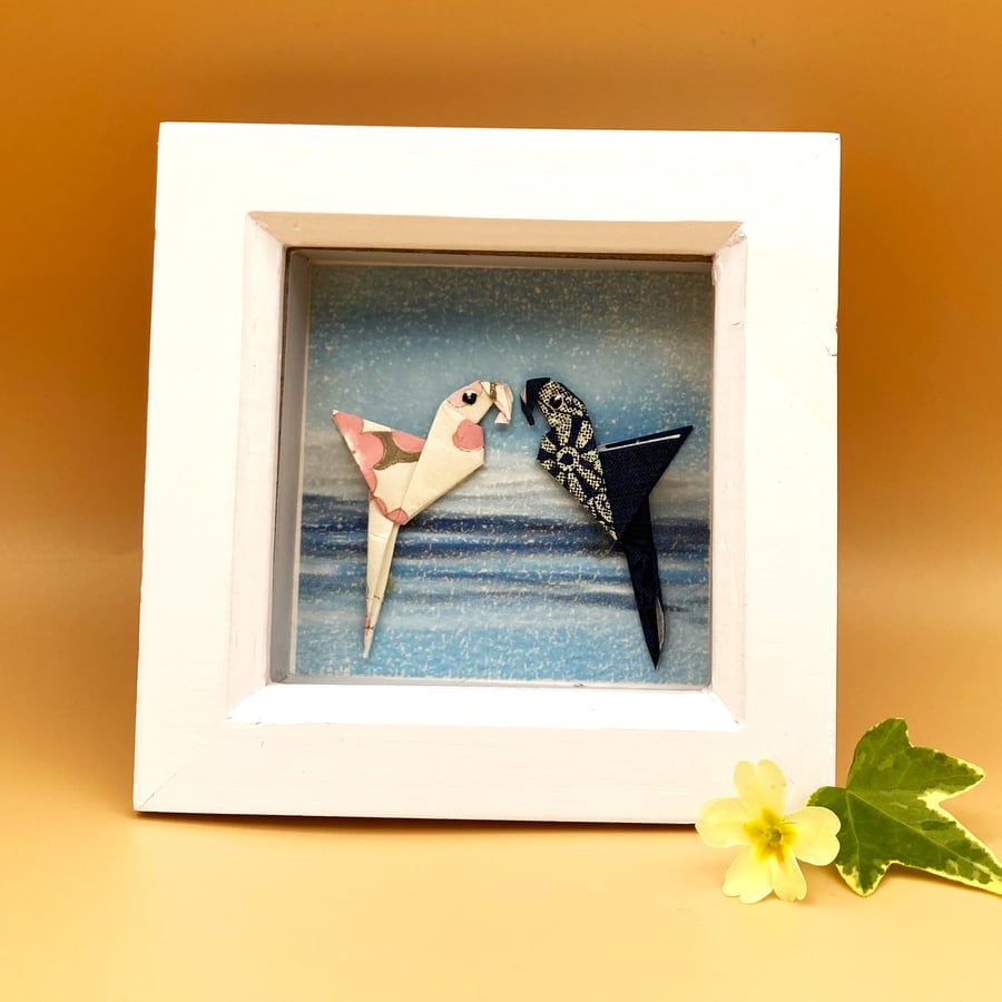 Hand folded Origami Parrots on a print background, original picture in box frame