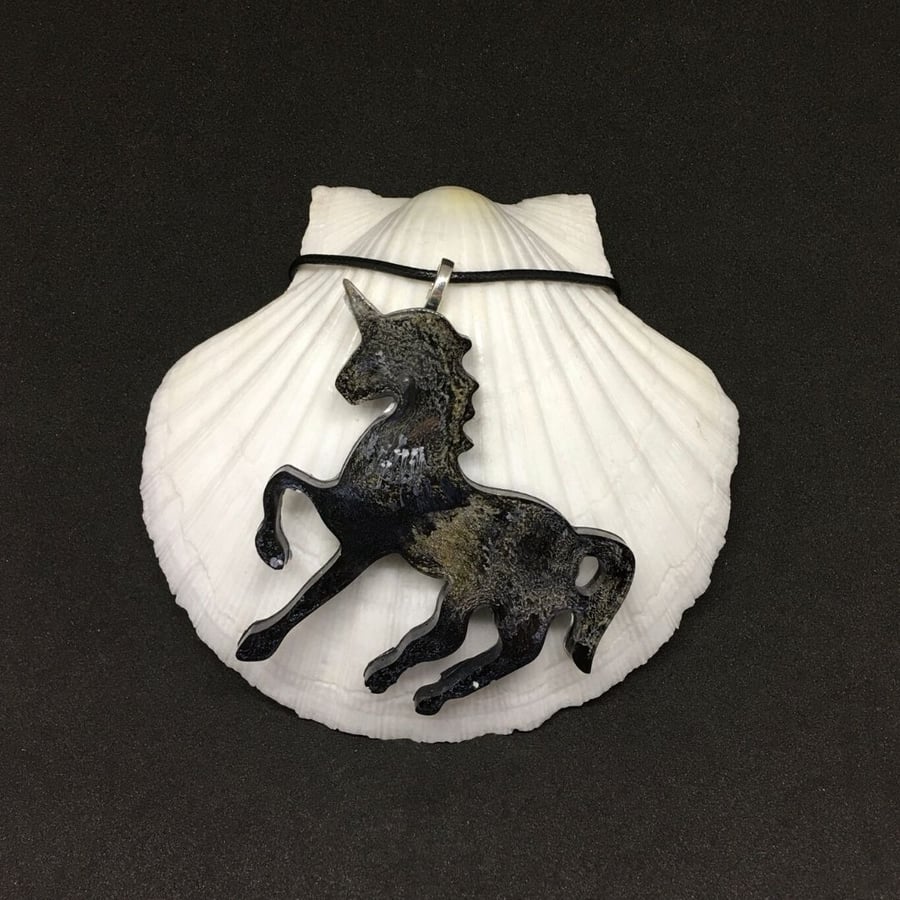 Black and silver unicorn statement pendant on black cord necklace.