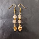 Gold pine cone charm dangle earrings with star detail beads