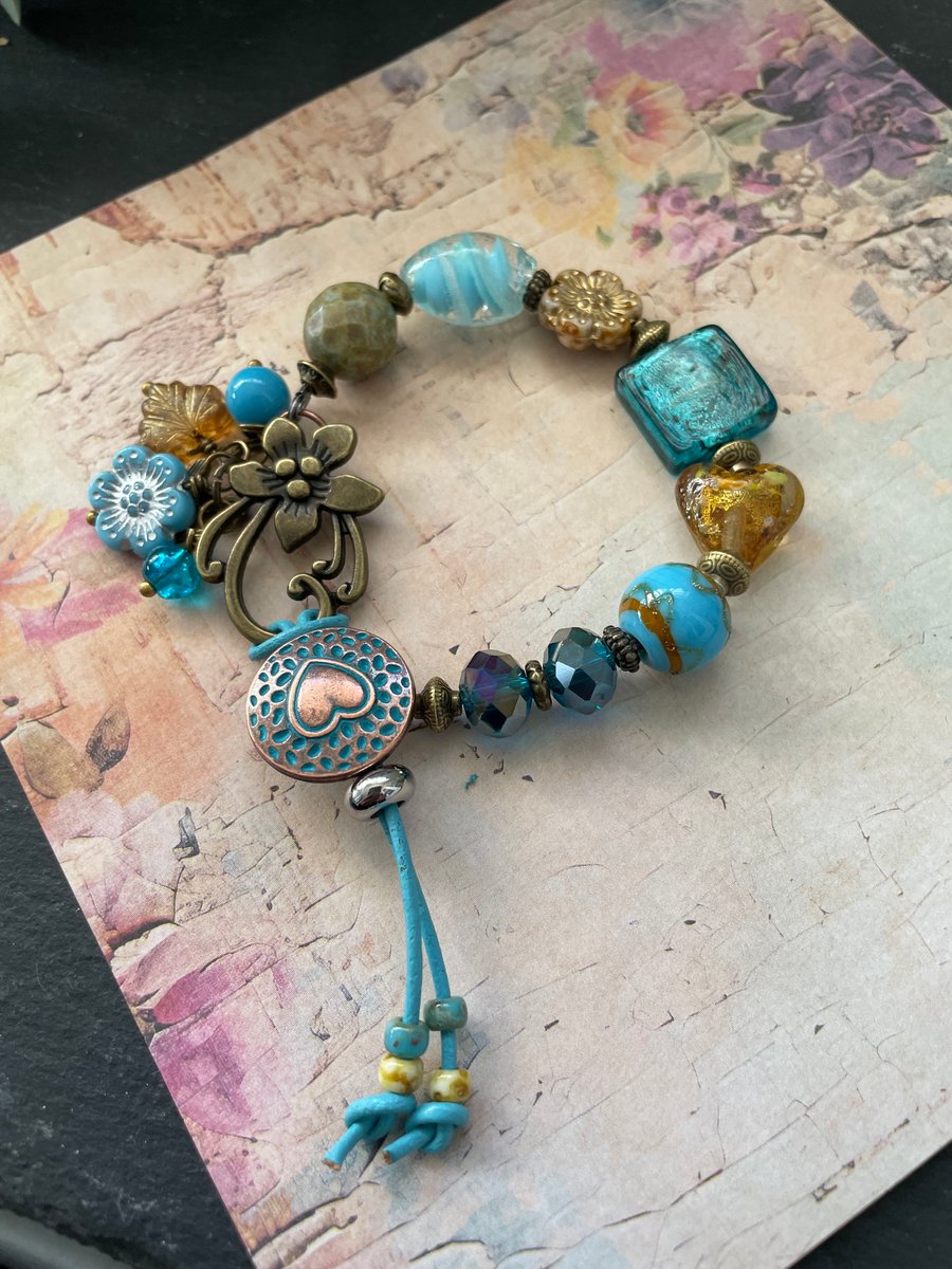 Charm bracelet, beautiful glass beaded artisan unique blue and amber bracelet