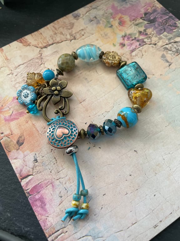 Charm bracelet, beautiful glass beaded artisan unique blue and amber bracelet