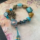 Charm bracelet, beautiful glass beaded artisan unique blue and amber bracelet