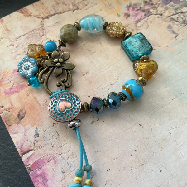 Charm bracelet, beautiful glass beaded artisan unique blue and amber bracelet