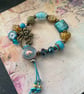 Charm bracelet, beautiful glass beaded artisan unique blue and amber bracelet