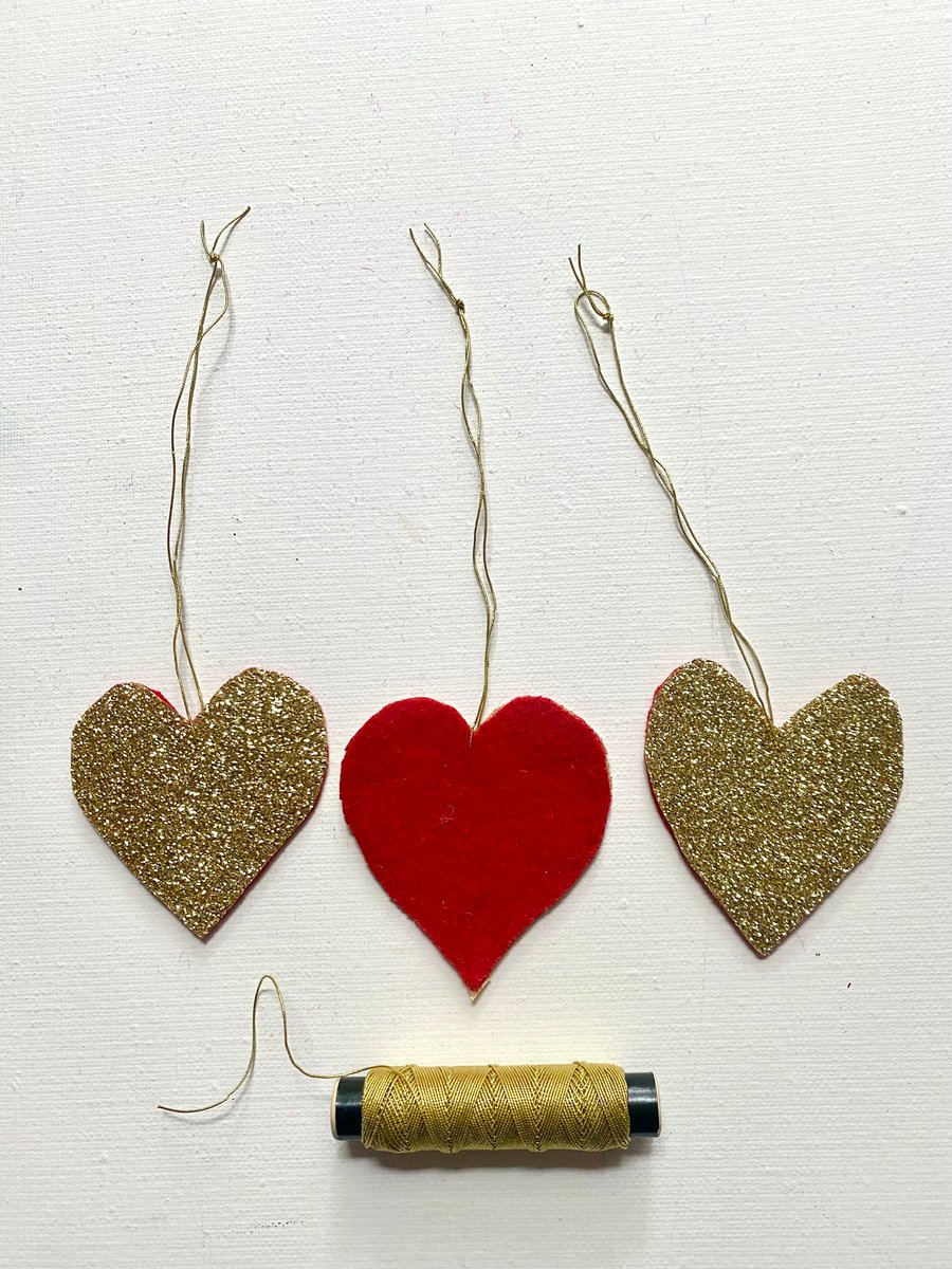 A trio of  glittering hanging Christmas hearts 