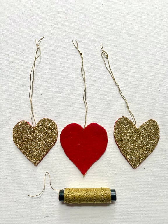 A trio of  glittering hanging Christmas hearts 