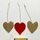 A trio of  glittering hanging Christmas hearts 