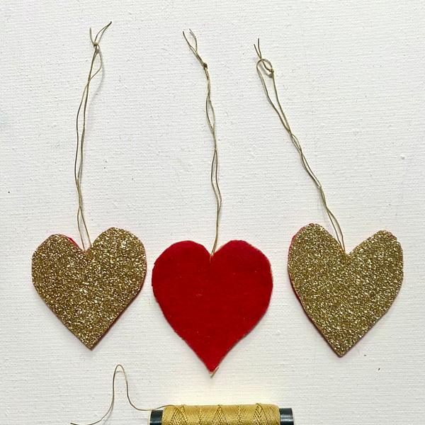 A trio of  glittering hanging Christmas hearts 