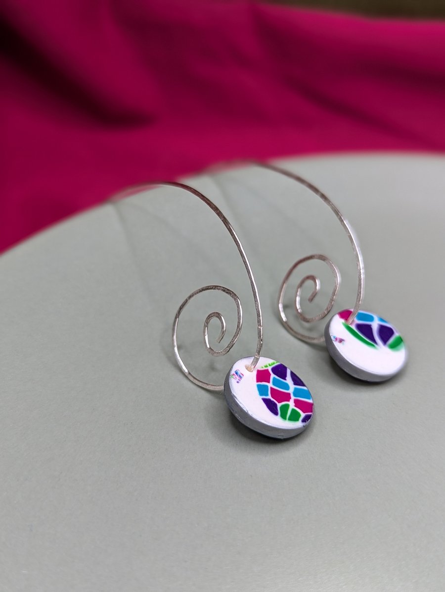 Long spiral earrings with jewel mosaic look disc.