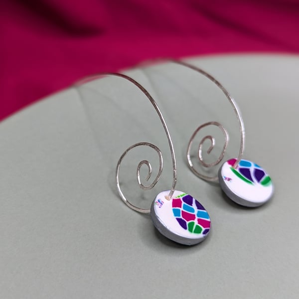 Long spiral earrings with jewel mosaic look disc.