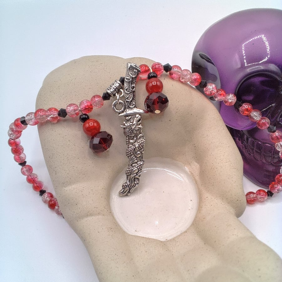 Silver Dagger Pendant on a Red Bead Necklace With Red and Black Bead Charms